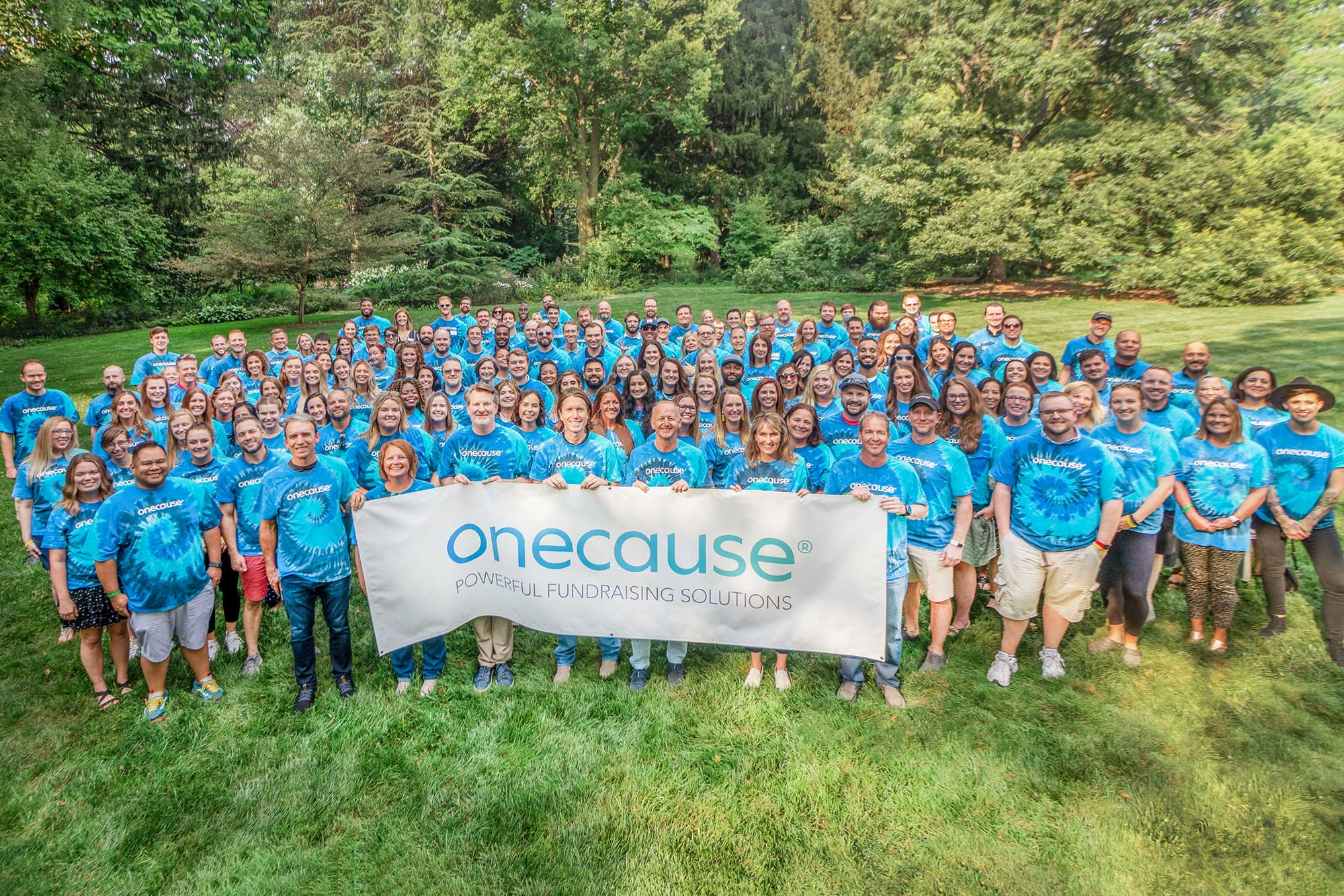 OneCause supporters holding a banner